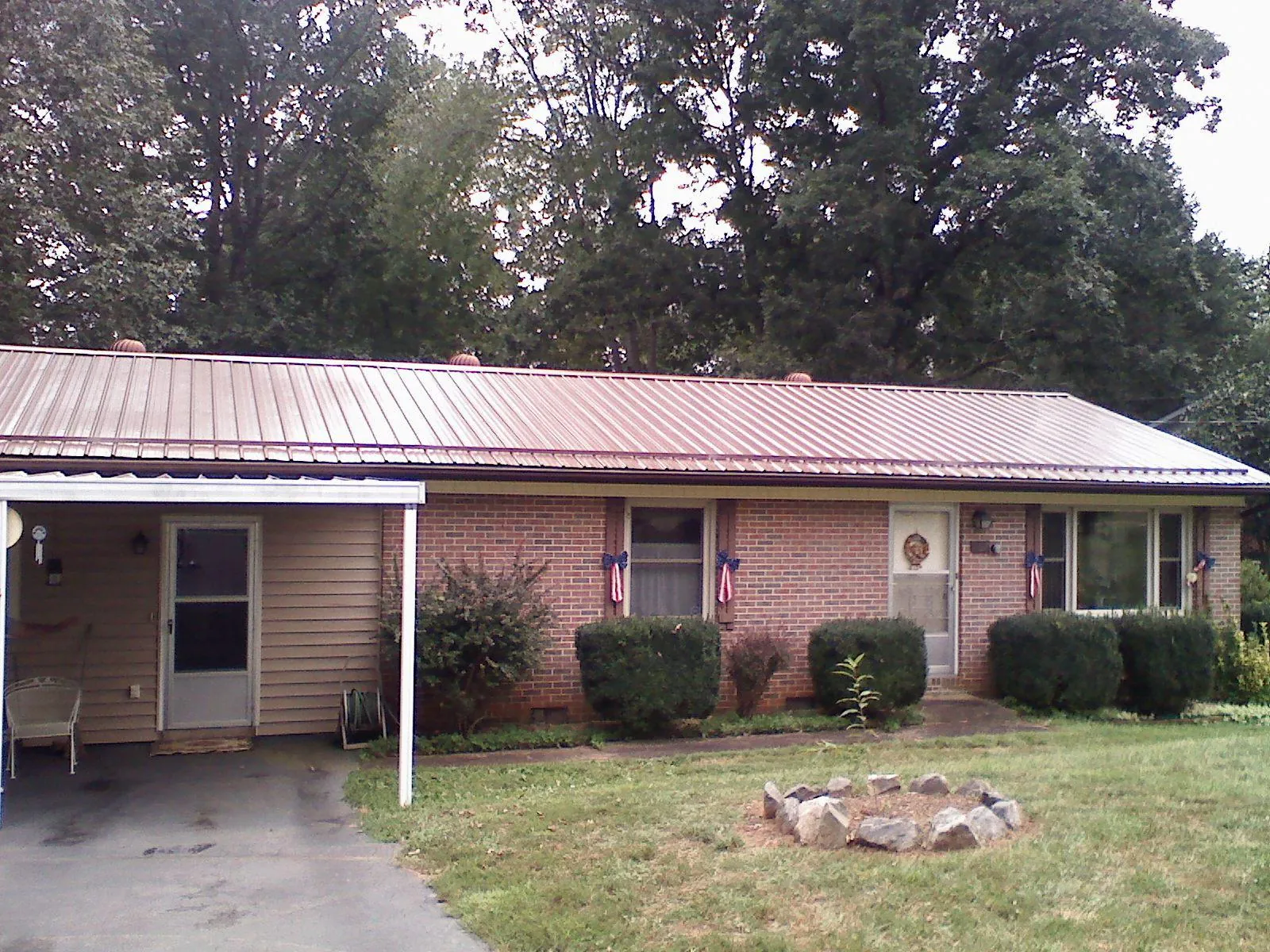 Bronze metal roof and carport on a brick ranch home — Roof Repair work by our crew in New Middletown