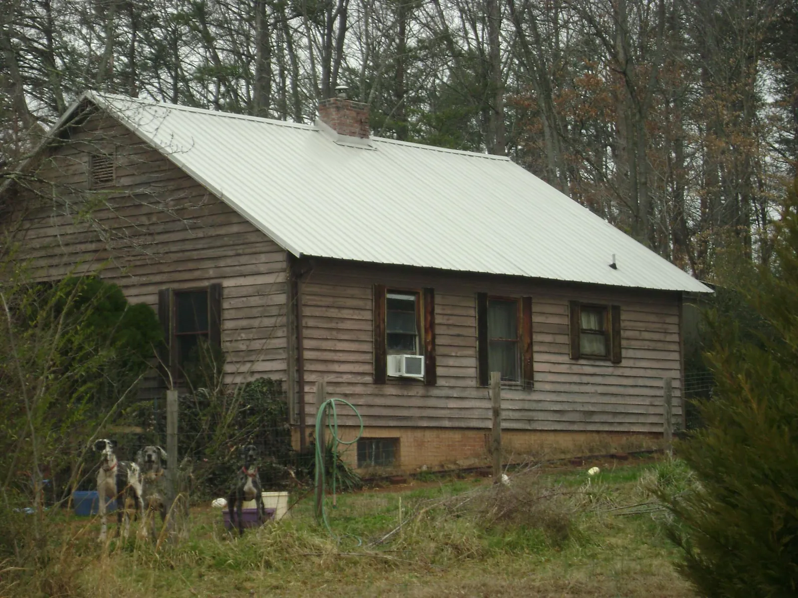 White metal roof on an old wood sided farmhouse, from a Metal Roof Installation job in New Middletown